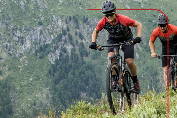 Two mountain bikers climbing